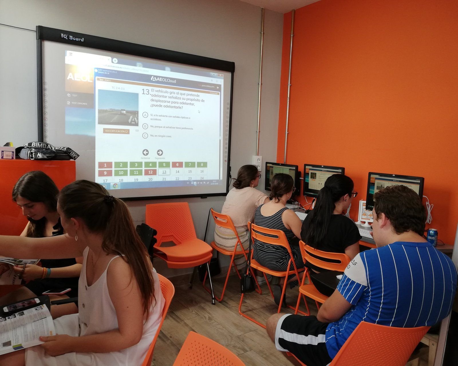 Aula teórica de City Autoescuela con un test DGT proyectado en la pizarra digital